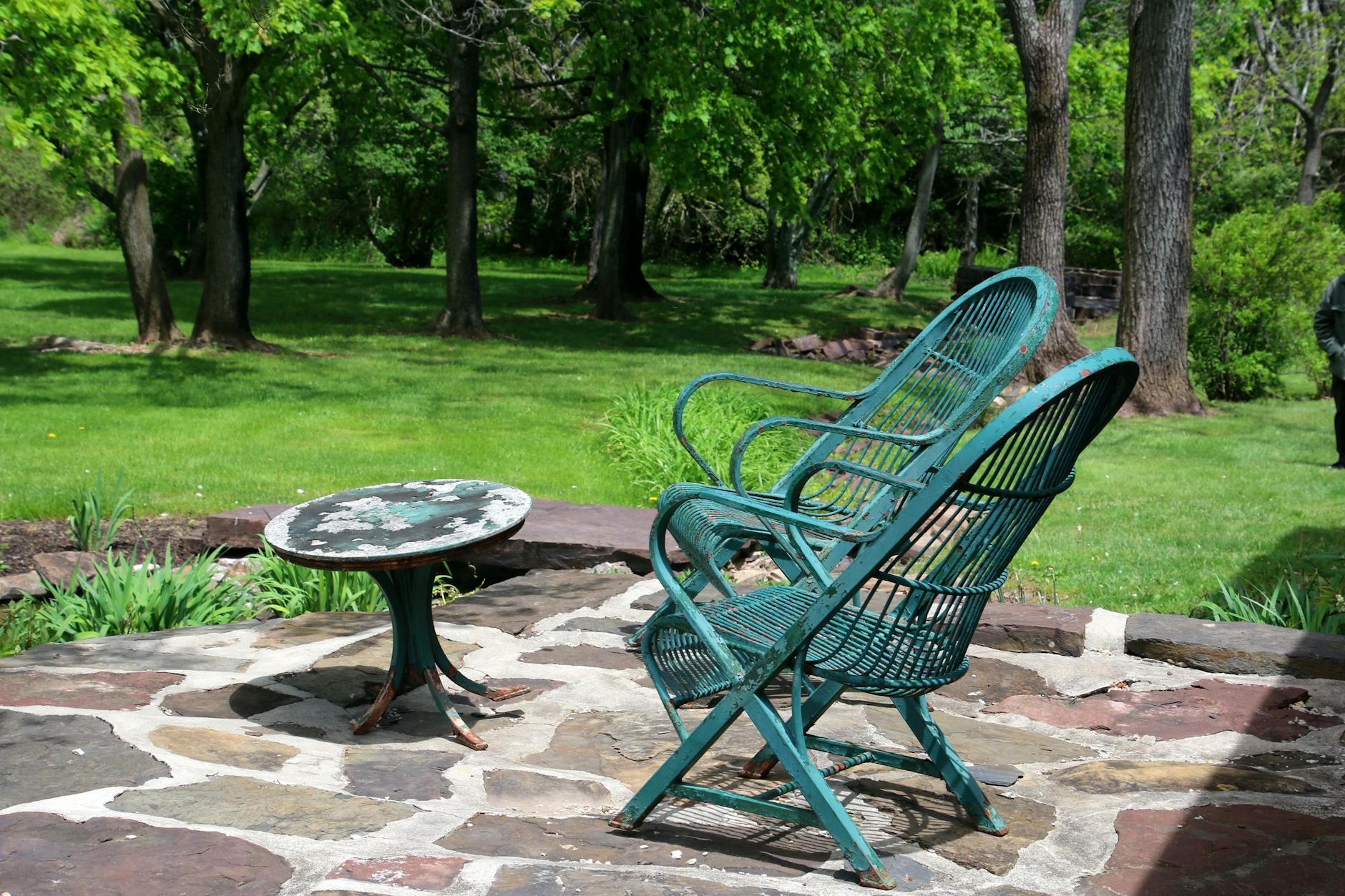 Stone patio outdoor living space with modern backyard design